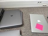 three laptops on the floor next to each other