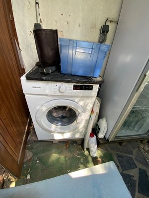 an image of a washing machine outside of a house
