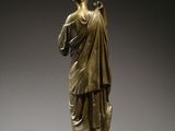 bronze statue of a man holding a bird on a pedestal