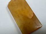 an image of a piece of yellow jade with writing on it
