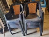two plastic chairs sitting next to each other in a garage