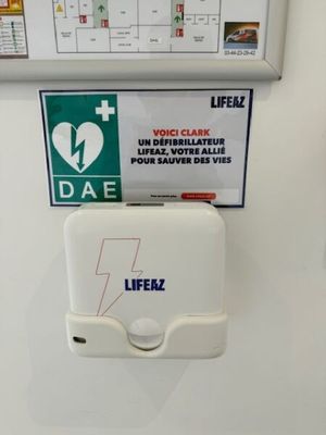 a white toilet with a sign on the wall above it