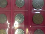 several different types of coins are in a pink plastic case