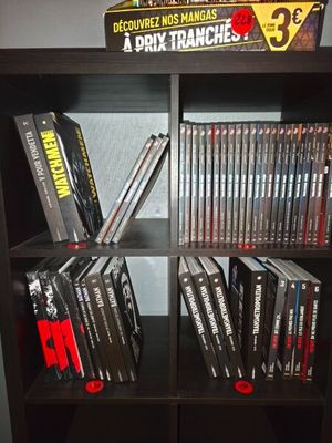 a book shelf with a bunch of dvds on it