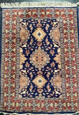 a blue and red rug with a medallion design on it