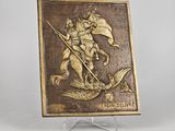 bronze plaque depicting a man riding a horse with a flag on it