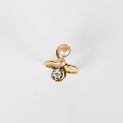 an image of a gold ring with a diamond and a pearl