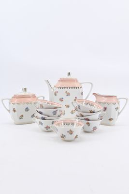 a white tea set with pink flowers on it