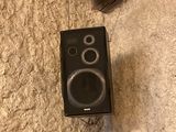 a speaker that is sitting on the floor next to a door