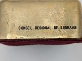 an old gold cigarette case with the words consei regional de lorraine on it