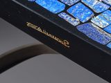 the table is made of glass and has a blue mosaic pattern on it