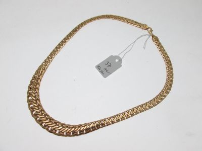 a close up of a gold chain with a price tag on it