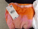 a pink and orange tie dyed bag with a price tag on it