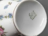 a close up of a cup and saucer on a table