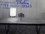 a table with a lamp on it in front of a wall with writing on it