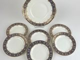a set of six porcelain plates with gold and blue designs