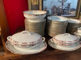 many plates and bowls sitting on a shelf in a room