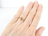 a woman ' s hand with a gold ring on it