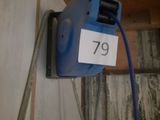 a blue blow dryer attached to a wall with a number 79 on it