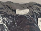 a black shirt that is wrapped in a plastic bag