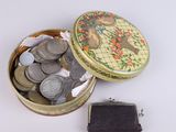 a small metal box with coins inside of it