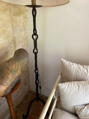 a lamp that is next to a bed in a room