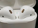 an image of a pair of white airpods sitting in a case