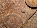 a close up of a rusted metal object with a hole in the middle