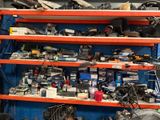 many different types of tools on the shelves in the garage