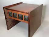 a small wooden table with a drawer on top of it