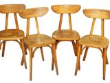 four wooden chairs are lined up against a white background