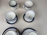 quatre tasses et deux soucoupes posées sur une table