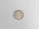 a close up of a silver coin on a white surface