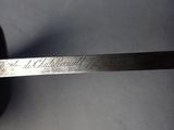 a close up of a knife on a table with writing on it