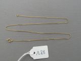 a close up of a gold chain with a price tag attached to it