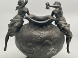 deux statues posées au sommet d'un vase