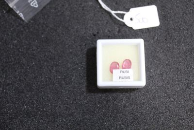 a small square button with two red hearts on it
