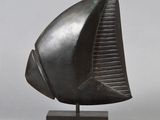 bronze sculpture of a boat on a stand on a gray background