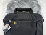 a close up of a black laptop bag on a white surface