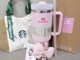 a starbucks cup, a bag, and a keychain sitting on a table