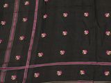 a close up of a black sari with pink flowers on it
