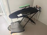 a black ironing board sitting on top of an ironing board