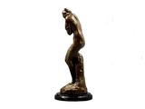 statue of a woman holding her head in her hands