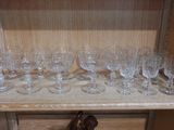a wooden shelf with a bunch of wine glasses on it