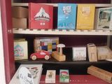 many books on the shelves in the red cabinet