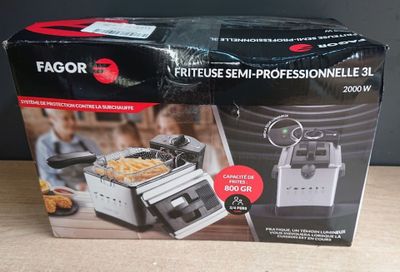 the box is open on the table with the fryer in it