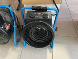 two portable heaters sitting on the floor next to each other