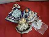 three dolls sitting on a red couch next to each other