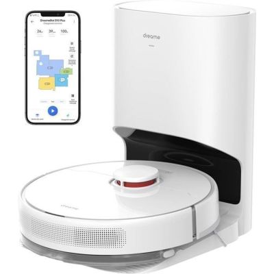 un gros plan d'un robot blanc posé sur une table à côté d'un téléphone