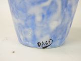 a blue and white cup with a black writing on it